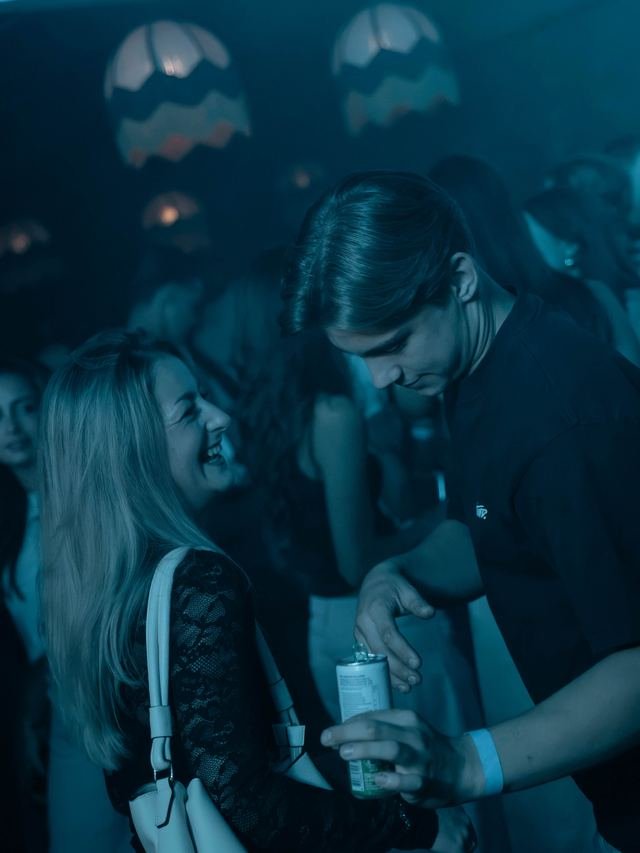 Publiek lacht en danst in het blauwe licht